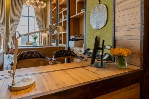 a wooden desk with a computer on top of it at Bengodi Boutique Hotel in Eceabat