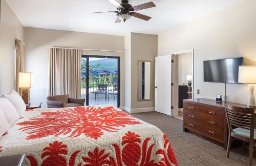 a bedroom with a bed and a flat screen tv at Wyndham Royal Sea Cliff Resort in Kailua-Kona