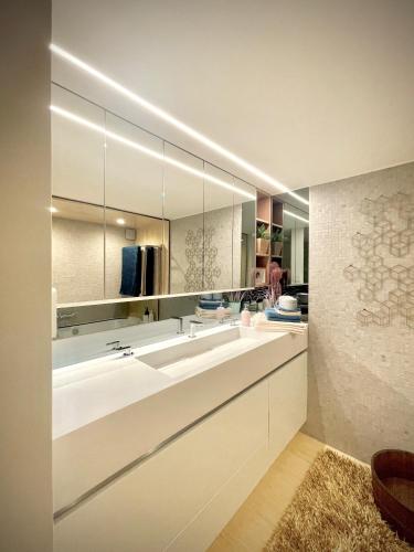 a bathroom with two sinks and a large mirror at Desk Till Dawn in Ghent