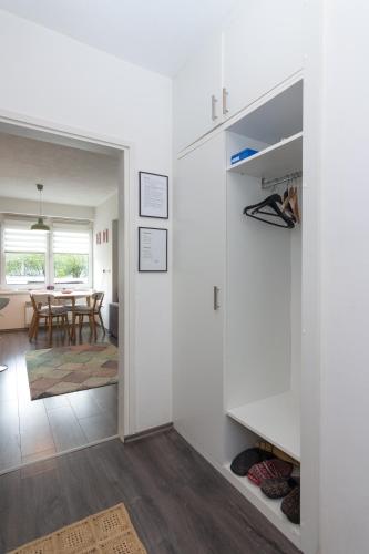 a room with white walls and a dining room with a table at Apartment Amra in Visoko
