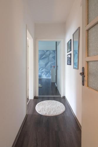 a hallway with a door and a rug on the floor at Apartment Amra in Visoko