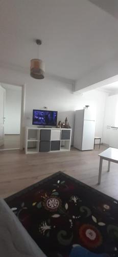 a living room with a tv and a rug at Apartament central. Bloc nou. in Bacău