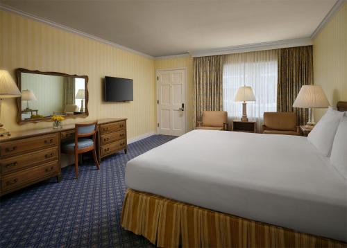 a hotel room with a large bed and a desk at Little America Hotel - Wyoming in Little America