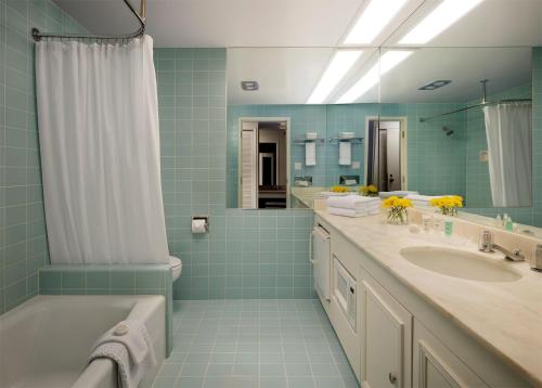 a bathroom with a tub and a sink and a shower at Little America Hotel - Wyoming in Little America