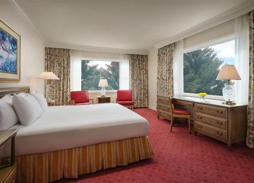 a hotel room with a large bed and a desk at Little America Hotel - Wyoming in Little America