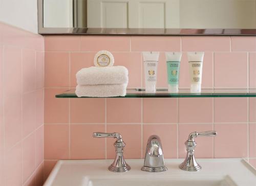 a bathroom with a sink and a shelf with towels at Little America Hotel - Wyoming in Little America