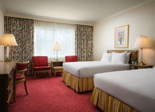 a hotel room with two beds and a window at Little America Hotel - Wyoming in Little America