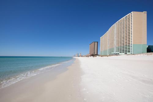 a view of the beach with buildings in the background at Club Wyndham Panama City Beach in Panama City Beach