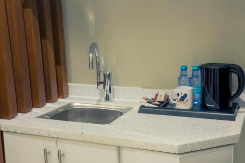 a kitchen counter with a sink and a coffee maker at 92 - وحدات فندقية - in Unayzah