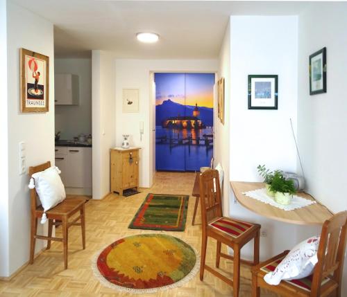 a living room with a door open to a kitchen at Homely Apartment in the Center with Garden View in Gmunden