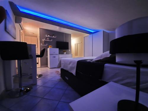 a bedroom with a bed and a blue light at Apartmani Vera in Bibinje