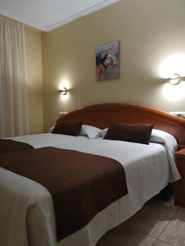 a hotel room with two beds in a room at Hostal Stella Del Mare in Camariñas