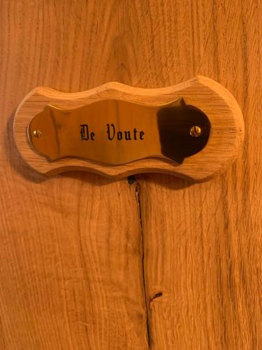 a wooden guitar sitting on a wooden table at B&B De Rentmeesterhoeve in Reningelst