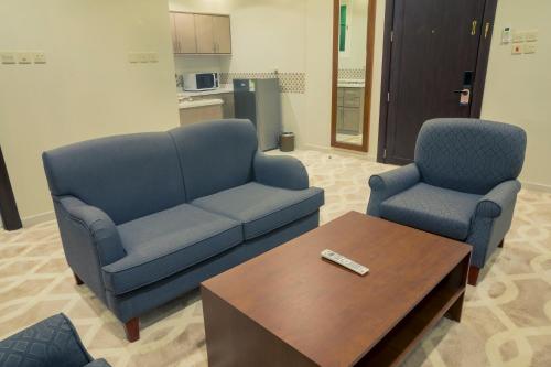 a living room with a couch and two chairs and a coffee table at 92 - وحدات فندقية - in Unayzah