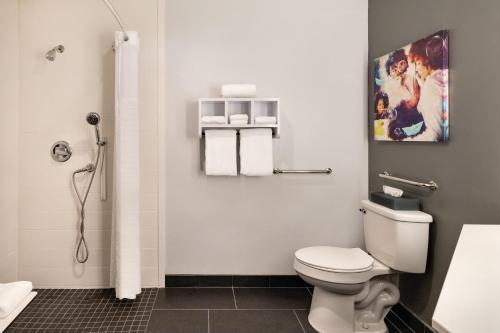 a bathroom with a toilet and a shower at La Quinta inn & suites by Wyndham Dothan in Dothan