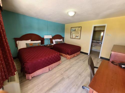 A bed or beds in a room at America's Value Inn
