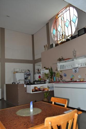 サン・ジョアン・ダ・ボア・ビスタにあるPousada Recanto da Estaçãoのテーブルとステンドグラスの照明のあるキッチン