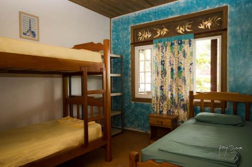 a room with two bunk beds and a window at Spanish by the Sea - Bocas in Bocas del Toro