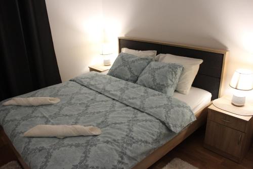 a bedroom with a large bed with two night stands at Apartment Anagastum in Nikšić