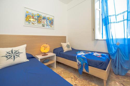 a bedroom with two beds and a window at Dimore di mare - Beachfront Apartments in Santa Flavia