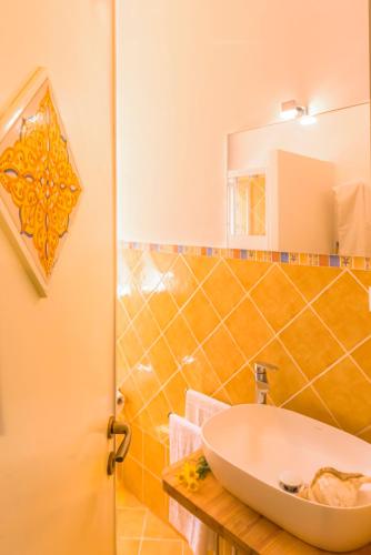 a bathroom with a sink and a mirror at Dimore di mare - Beachfront Apartments in Santa Flavia