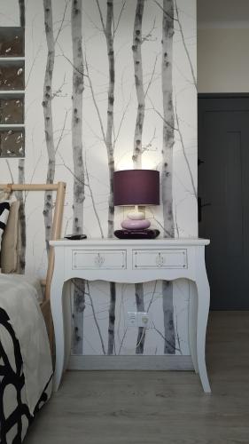 a white table with a lamp on it in a bedroom at Forever São Brás in São Brás de Alportel