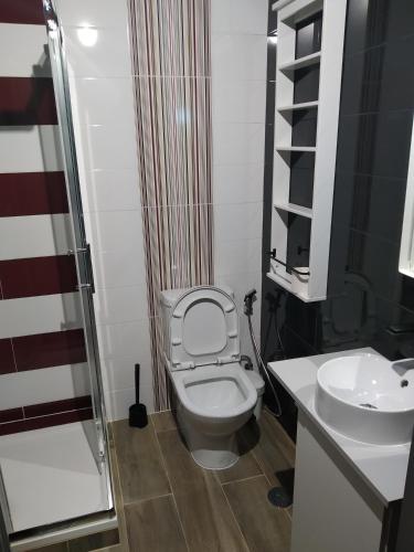 a bathroom with a toilet and a sink at Forever São Brás in São Brás de Alportel