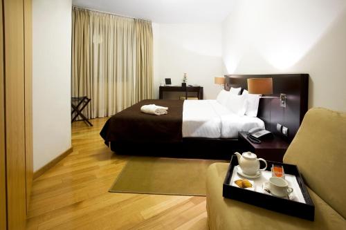 Llit o llits en una habitació de Hotel Conde de Agueda