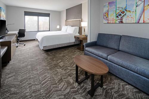 a hotel room with a couch and a bed at Best Western Valencia/Six Flags Inn & Suites in Santa Clarita