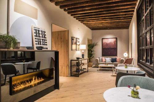 阿維拉的住宿－Sofraga Palacio, World Hotels Crafted，客厅设有壁炉和沙发。