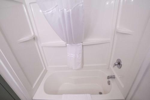 a bathroom with a toilet with a shower curtain at Prestige Hudson Bay Lodge & Conference Centre, WorldHotels Crafted Collection in Smithers