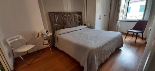 a bedroom with a bed and two chairs in it at La Luna nel Borgo in Brugnato
