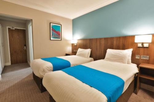 a hotel room with two beds in a room at The Jephson Hotel; BW Signature Collection in Leamington Spa