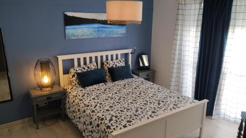 a bedroom with a white bed with blue walls at Forever São Brás in São Brás de Alportel