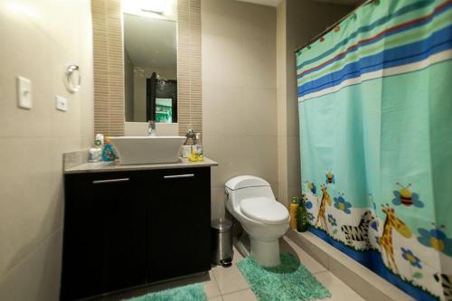 La salle de bains est pourvue de toilettes, d'un lavabo et d'une douche. dans l'établissement BlueLagoon Apartamento en Playa Blanča, à Playa Blanca