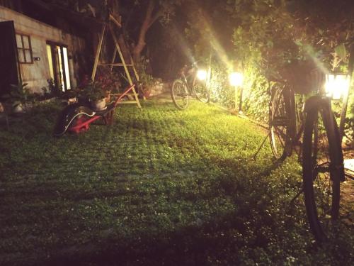 a bike parked in a yard at night at oniron in Sidhirókastron