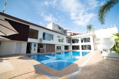 an exterior view of a building with a swimming pool at Patio Pacific Resort in Boracay