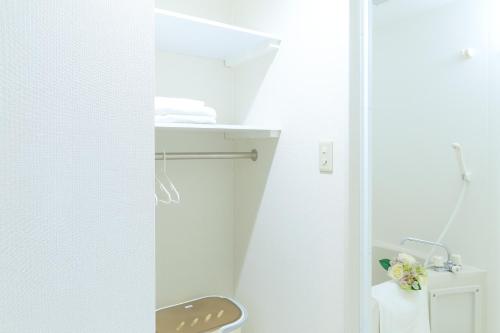 a bathroom with a toilet and a sink at Sakuragawa River Side Hotel in Osaka