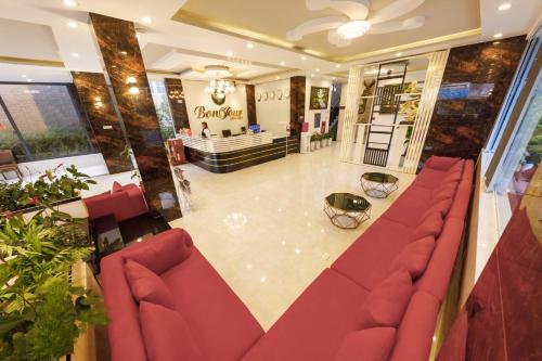 a lobby with red couches and a store at Bonjour Da Lat Hotel in Da Lat