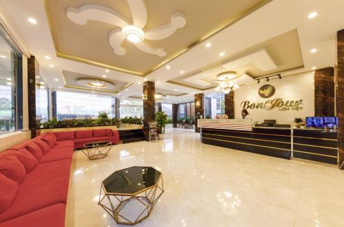 a lobby with a red couch and a store at Bonjour Da Lat Hotel in Da Lat