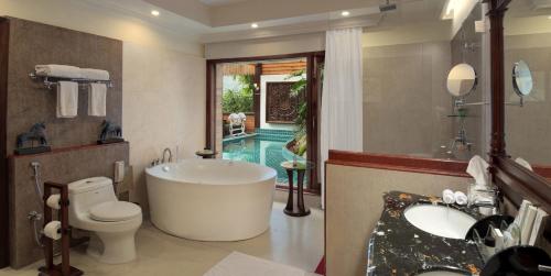 a bathroom with a tub and a toilet and a sink at Mayfair Spa Resort & Casino in Gangtok