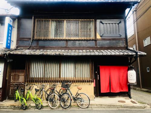 
a bike parked next to a building with a window at Guesthouse KYOTO COMPASS in Kyoto
