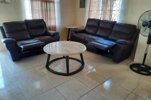 a living room with a couch and a coffee table at Rick's Reggae Villa in Montego Bay