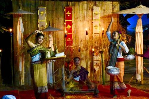 a painting of three women and a man on a stage at Ban Rai Jai Chaem - Spa Cafe & Homestay in Ban Rai