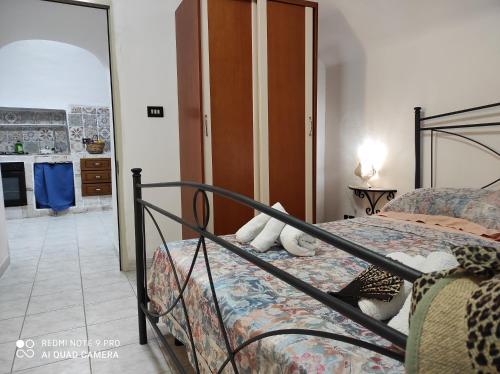 a bedroom with a bed with a teddy bear on it at Dimora dell'Isola Gallipoli in Gallipoli