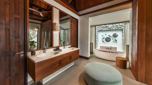 a bathroom with a tub and a sink and a bath tub at Villa Analaya in Kamala Beach