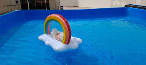 a dog is in a raft in a swimming pool at Hi Jeju Hotel in Jeju