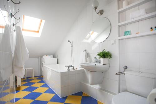 a bathroom with a sink and a toilet and a mirror at Hugo in Władysławowo