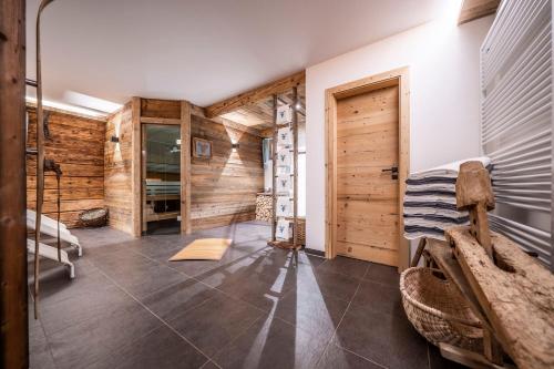 a bedroom with a bunk bed and wooden walls at Ferienwohnungen am Lahnerbach in Lenggries