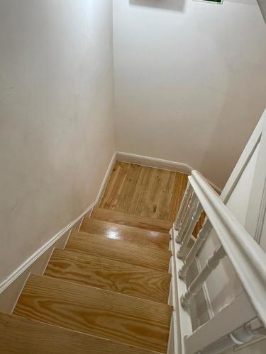 a set of stairs in a room with wood at Sweet Love Family II in Coimbra